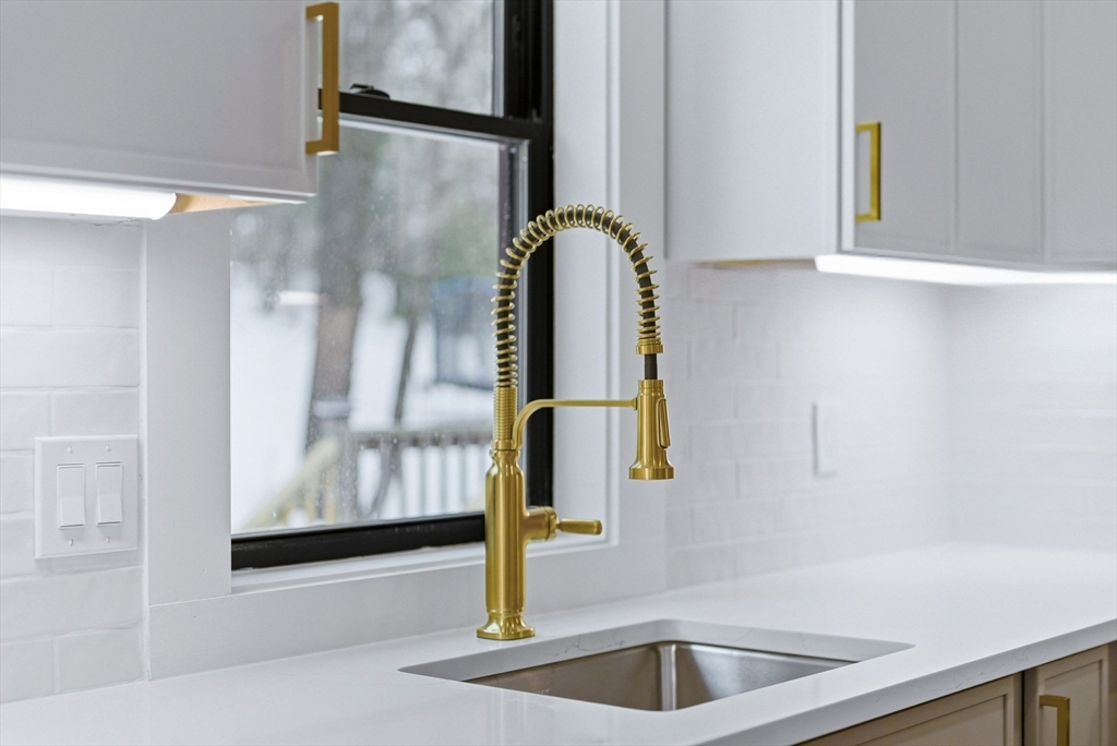 26 Rivulet Street Uxbridge, MA 01569 - Photo 13 of 41 a kitchen with a sink and mirror