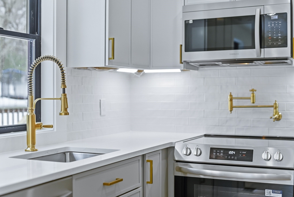 26 Rivulet Street Uxbridge, MA 01569 - Photo 14 of 41 a view of a kitchen counter space a stove and a sink