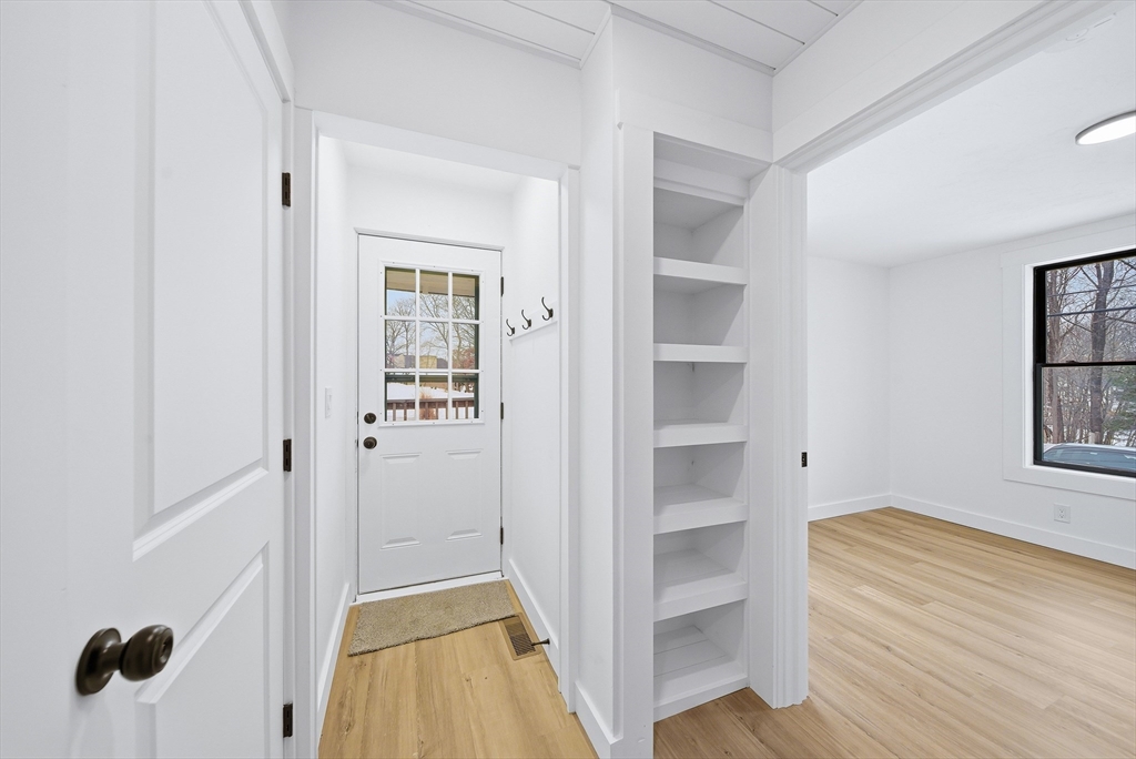 26 Rivulet Street Uxbridge, MA 01569 - Photo 16 of 41 a view of a hallway with wooden floor and closet