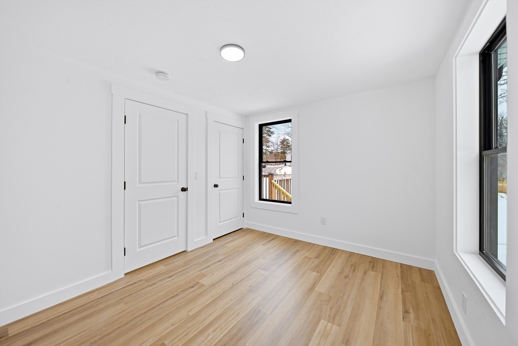 26 Rivulet Street Uxbridge, MA 01569 - Photo 23 of 41 an empty room with wooden floor and windows