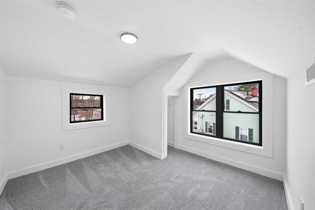 26 Rivulet Street Uxbridge, MA 01569 - Photo 26 of 41 an empty room with windows and ceiling fan
