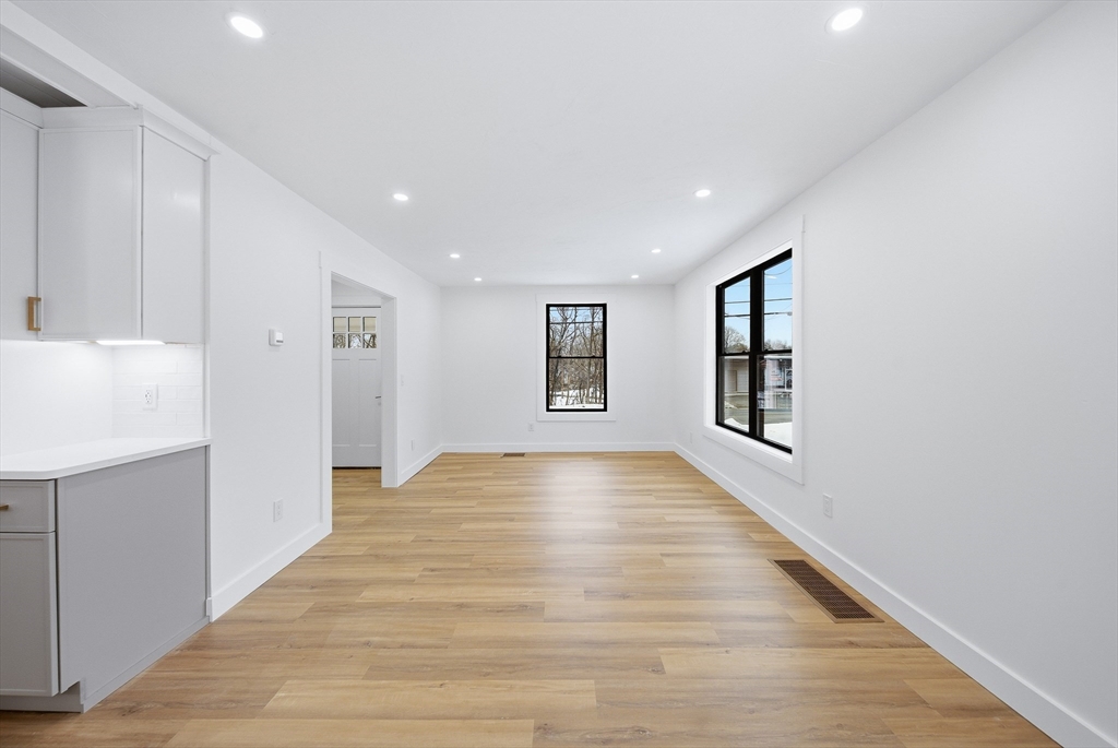 26 Rivulet Street Uxbridge, MA 01569 - Photo 6 of 41 a view of empty room with wooden floor and fan