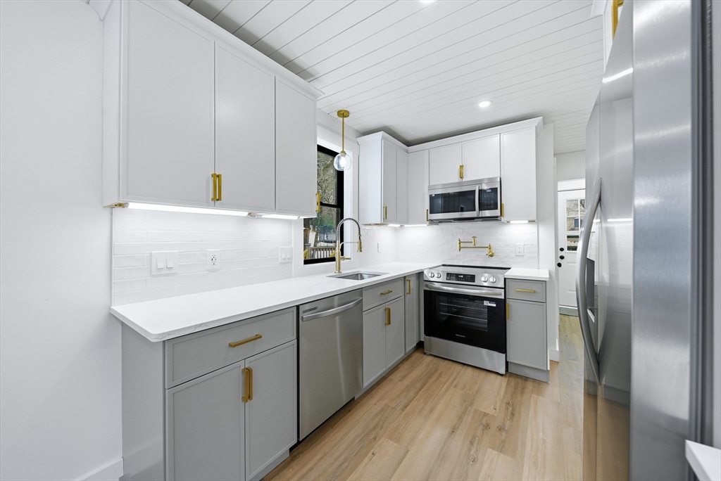 26 Rivulet Street Uxbridge, MA 01569 - Photo 10 of 41 a kitchen with kitchen island granite countertop a sink stainless steel appliances and cabinets