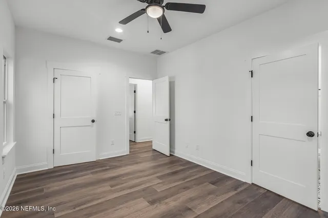 a view of a room with wooden floor