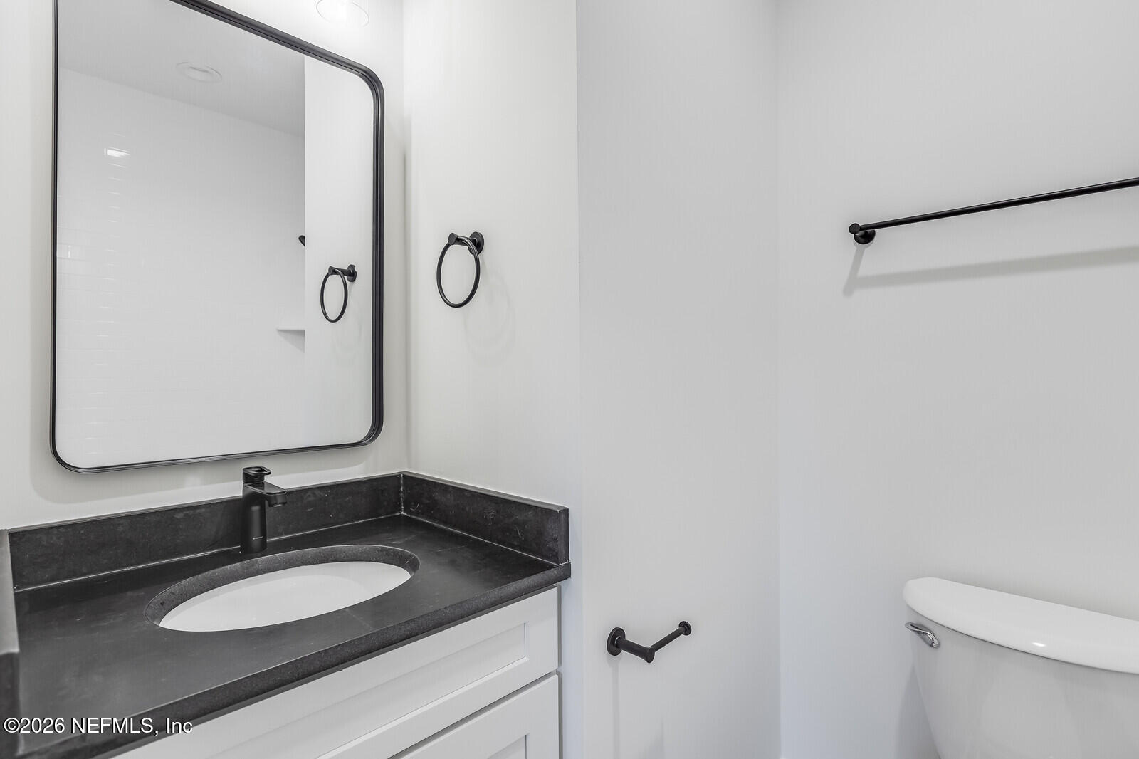 45055 Luther Street Callahan, FL 32011 - Photo 13 of 17 a bathroom with a granite countertop sink and a mirror