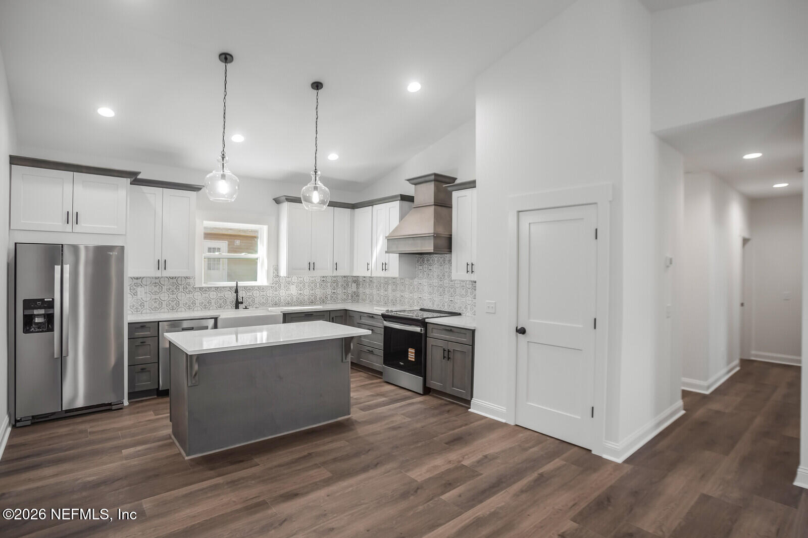 45055 Luther Street Callahan, FL 32011 - Photo 4 of 17 a large kitchen with stainless steel appliances granite countertop a stove and a refrigerator