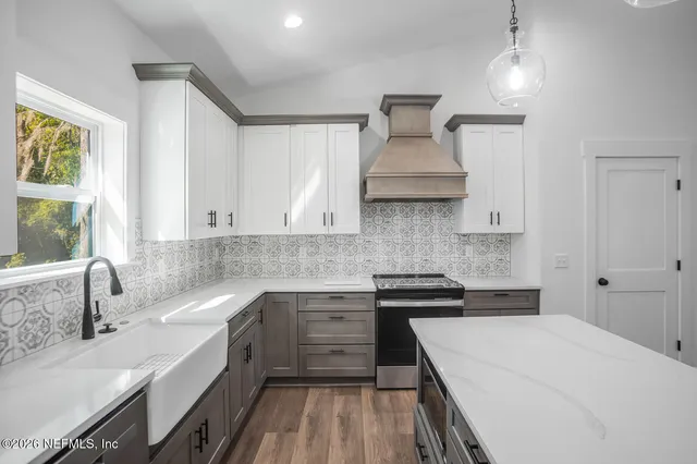 a kitchen with a sink stove and cabinets
