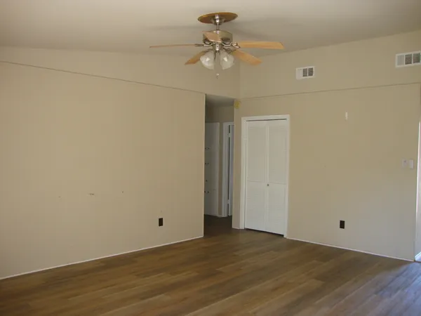 a view of an empty room and wooden floor