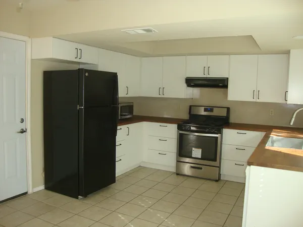 a kitchen with a stove and a refrigerator