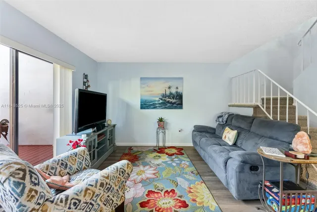 a bedroom with a bed and a lamp on dresser