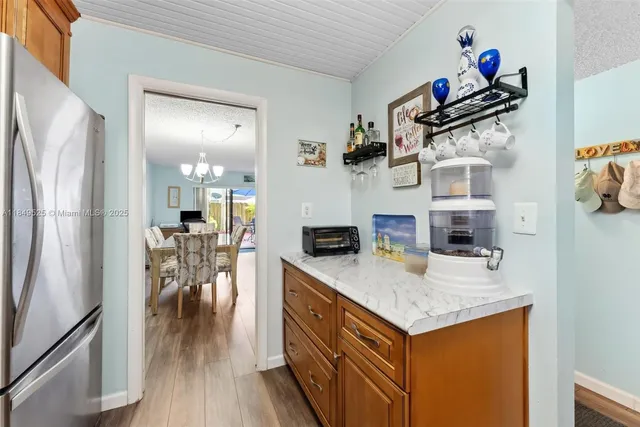 a kitchen with stainless steel appliances granite countertop a refrigerator a stove and a sink with cabinets