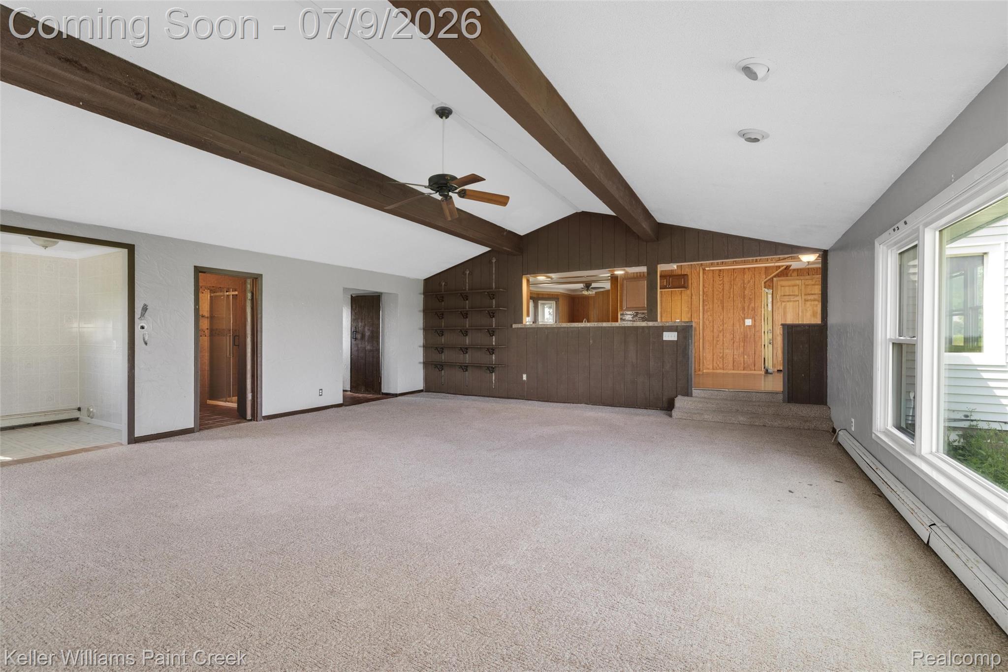 28780 School Section Road Richmond, MI 48062 - Photo 22 of 50 Spacious room featuring a vaulted ceiling with exposed beams, a ceiling fan, and light-colored carpeting