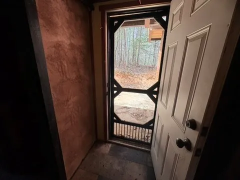 a backyard of a house with wooden fence and deck