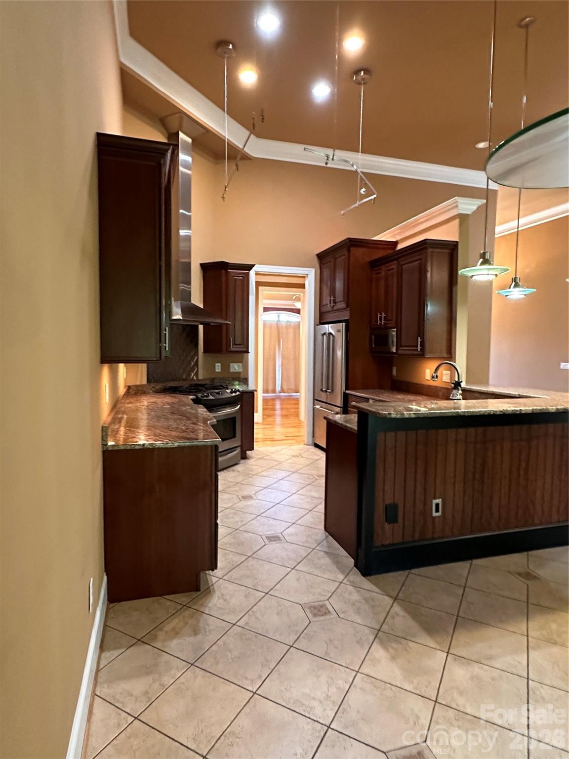 26 Stone House Road Arden, NC 28704 - Photo 7 of 21 a kitchen with granite countertop a refrigerator and a stove