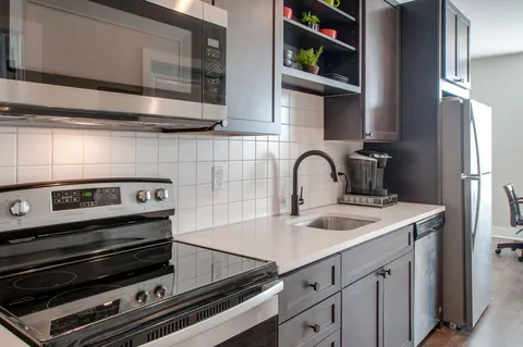 a kitchen with a sink and cabinets