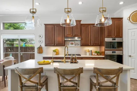 a bathroom with a granite countertop sink vanity mirror and toilet