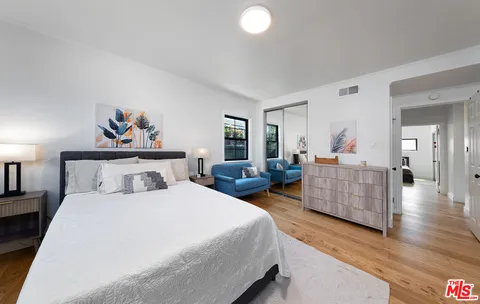 a bedroom with bed and a couch