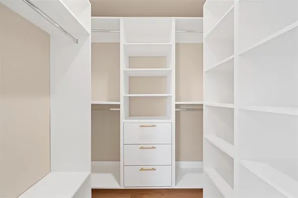 a kitchen with granite countertop a sink a counter top space stainless steel appliances and cabinets