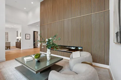 a kitchen with appliances a sink a counter top space and living room view