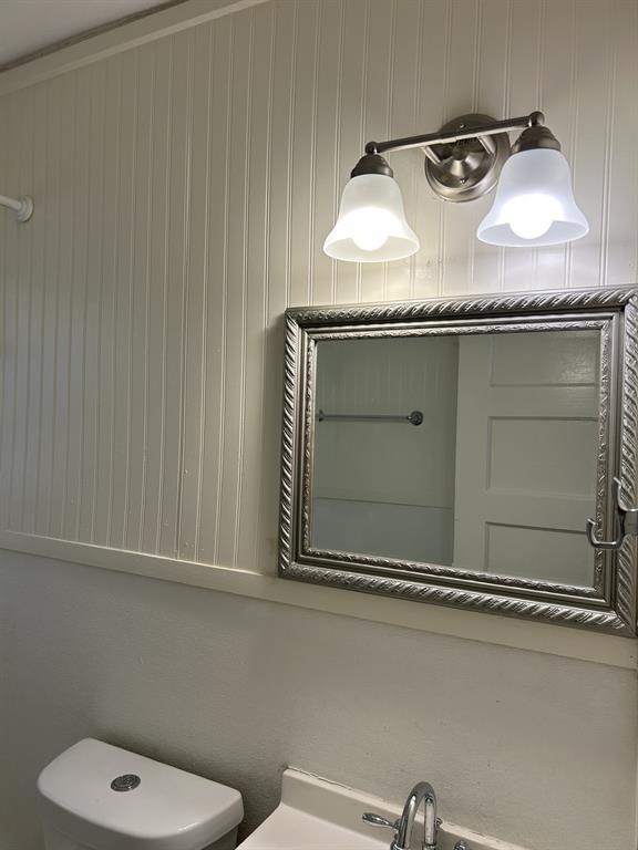 6318 Belgrade Avenue Dallas, TX 75227 - Photo 17 of 23 a bathroom with a granite countertop sink and a mirror