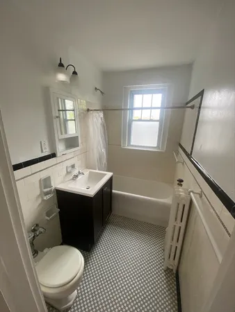 a bathroom with a sink toilet mirror and shower