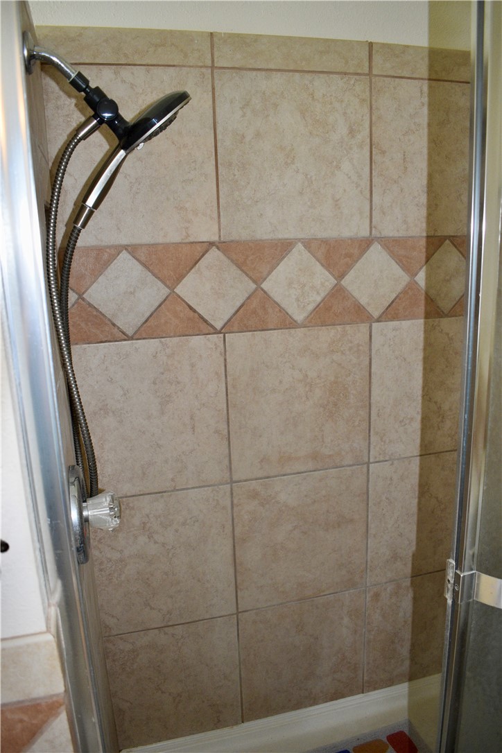 25051 Lake Shore Drive Mathis, TX 78368 - Photo 34 of 40 a bathroom with a shower and a window