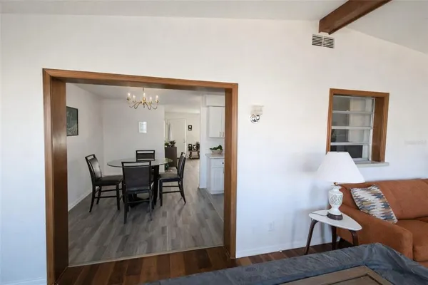 a dining room with furniture and wooden floor