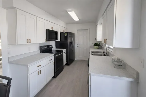 a kitchen with a sink stove and refrigerator