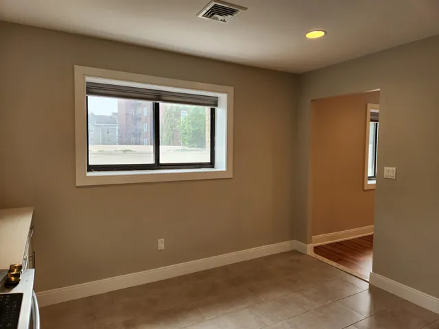a view of room with wooden floor and fan