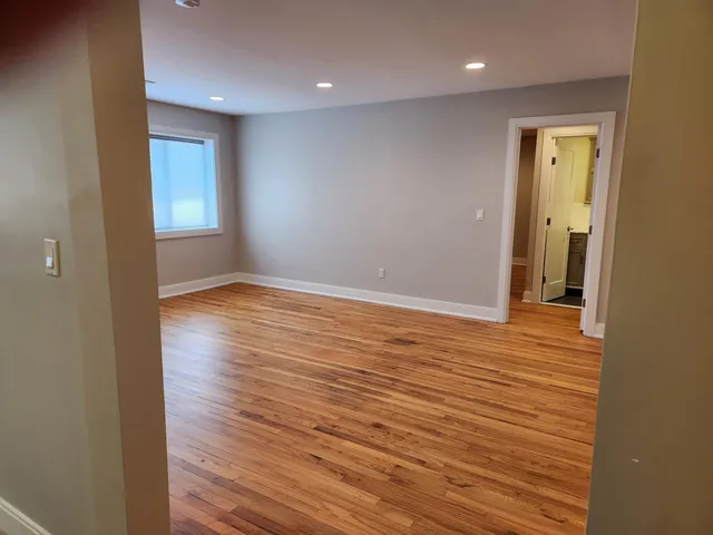 a view of staircase with wooden floor and white walls
