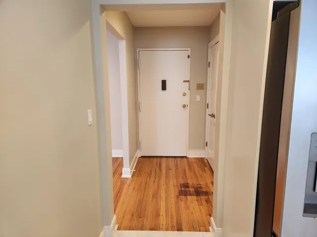 a kitchen with white cabinets stainless steel appliances and a counter space