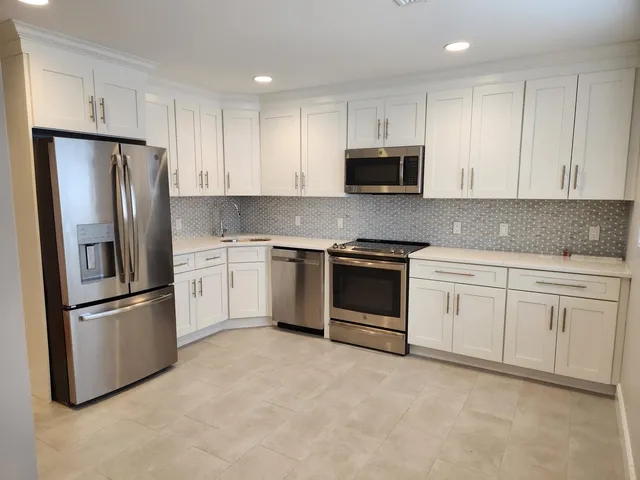 a bathroom with a granite countertop toilet sink and mirror