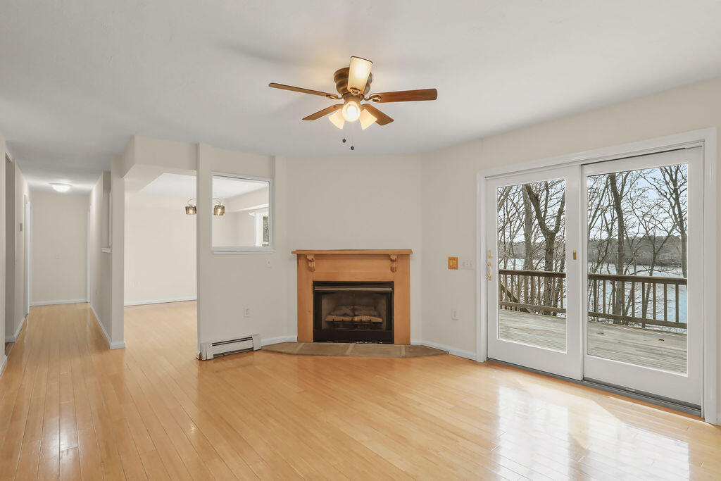 75 Edgewater Road Mashpee, MA 02649 - Photo 16 of 78 a view of an empty room with a fireplace and a window