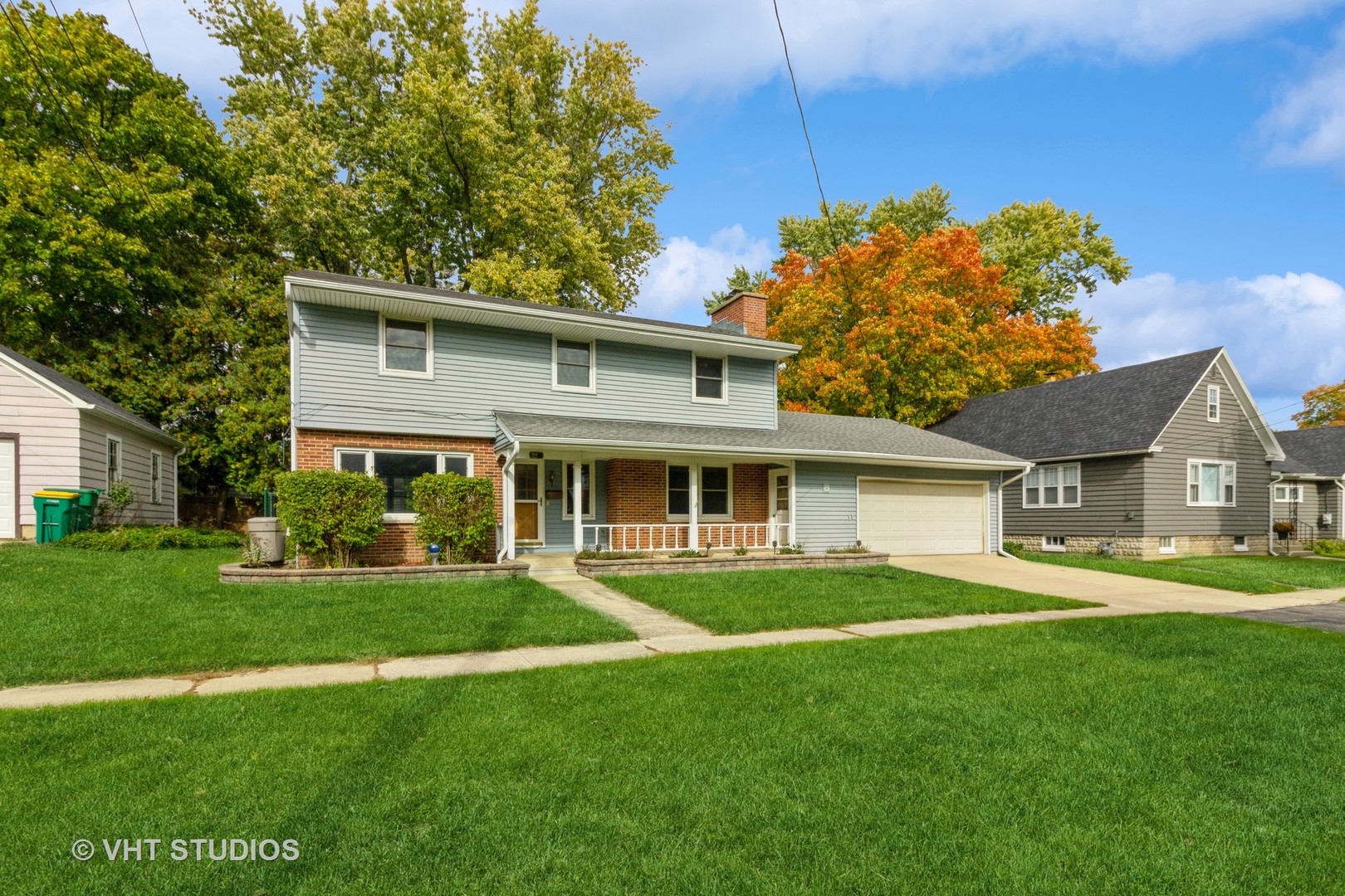 a front view of a house with a garden