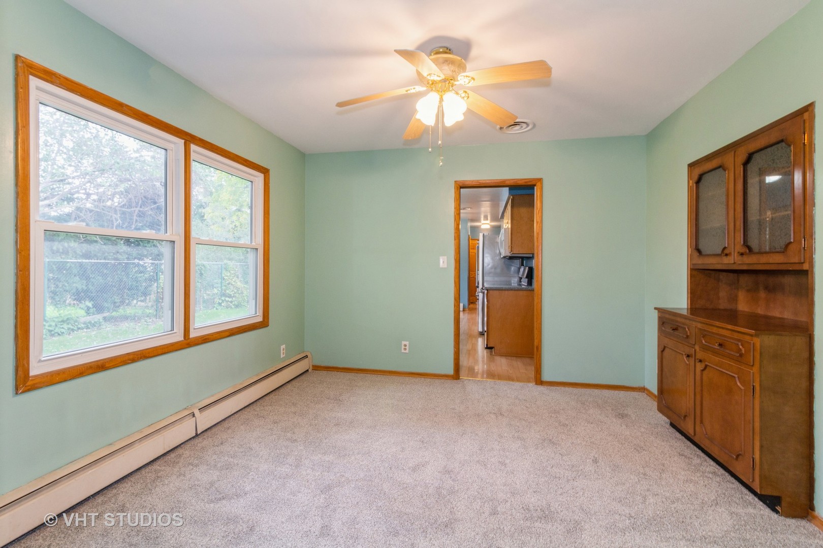 211 East Ottawa Street Sycamore, IL 60178 - Photo 6 of 33 an empty room with chandelier fan and windows