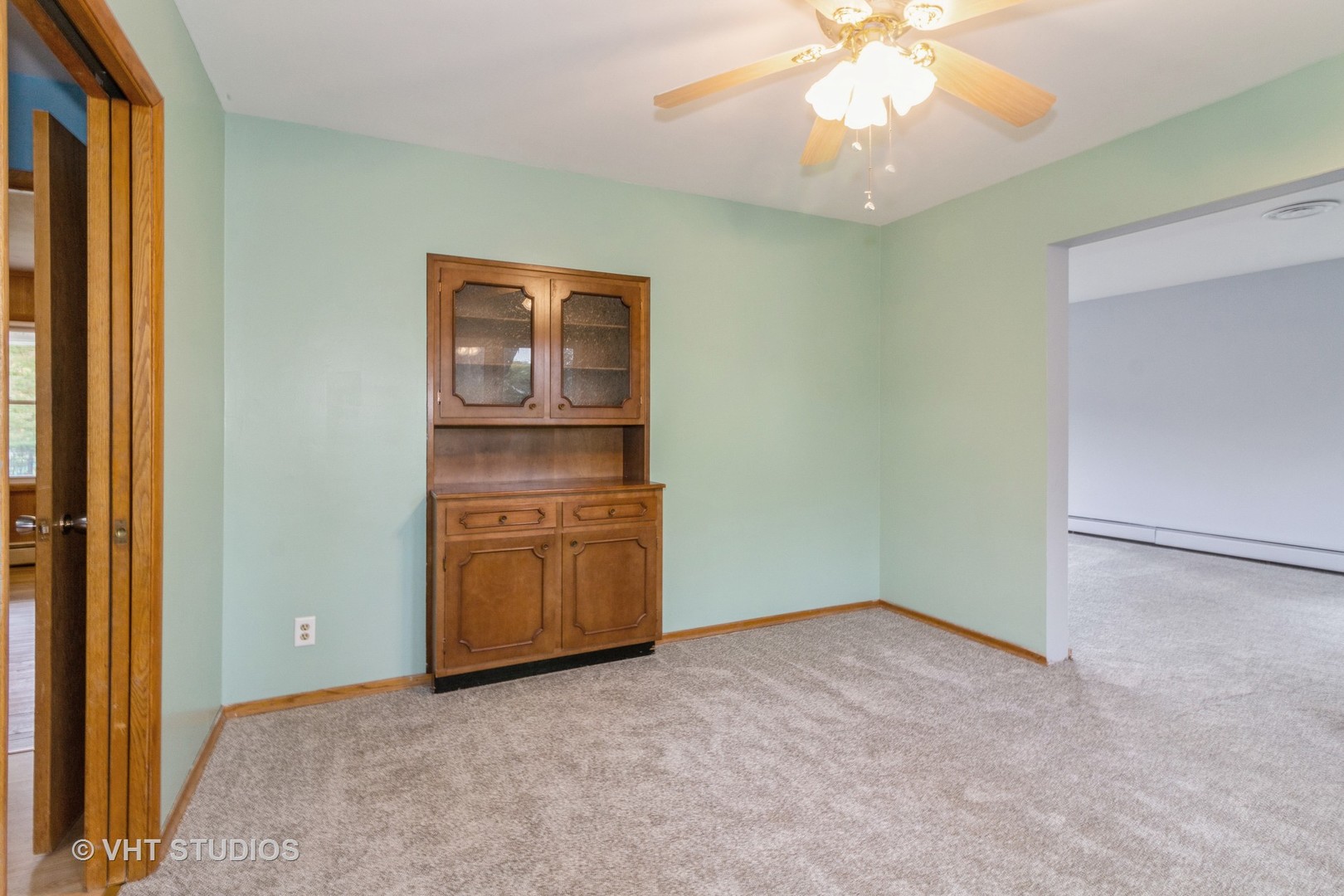 211 East Ottawa Street Sycamore, IL 60178 - Photo 7 of 33 an empty room with a chandelier fan and kitchen view