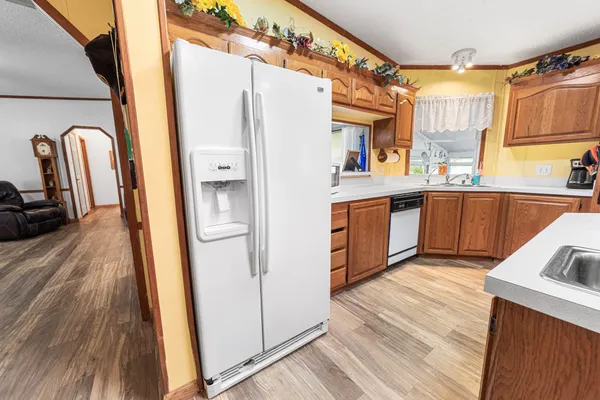 a kitchen with stainless steel appliances granite countertop wooden floors and table