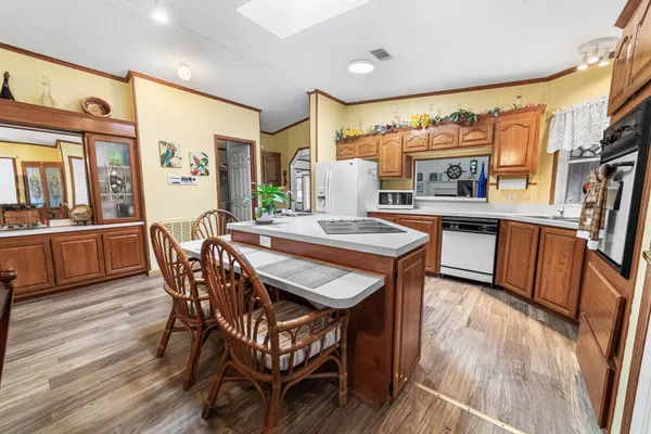 a view of a dining room with furniture large window and wooden floor