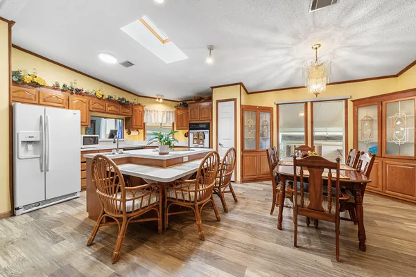 a dining room with furniture window and wooden floor