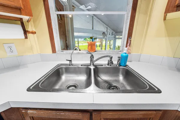 a view of a hallway with wooden floor and entryway door
