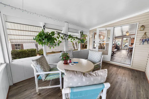 a view of a hallway with wooden floor and closet