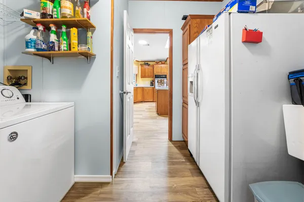 a bedroom with a bed and a lamp on dresser