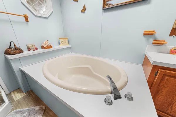 a view of a white house with a large tree s