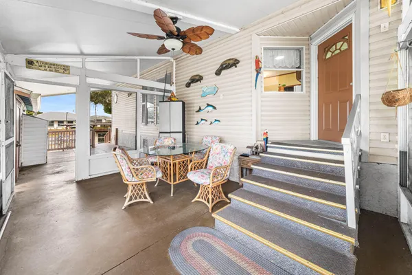 a view of a dining room with furniture and a chandelier