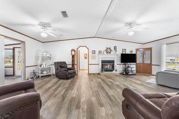 a living room with furniture fireplace and flat screen tv