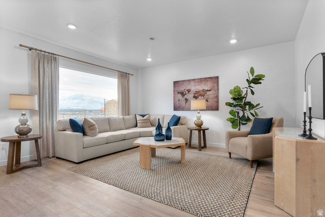 722 West 2840 South, Unit 8 Logan, UT 84321 - Photo 10 of 23 Living room with light wood-type flooring, recessed lighting, and a mountain view