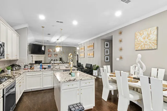 a kitchen with a sink window and cabinets