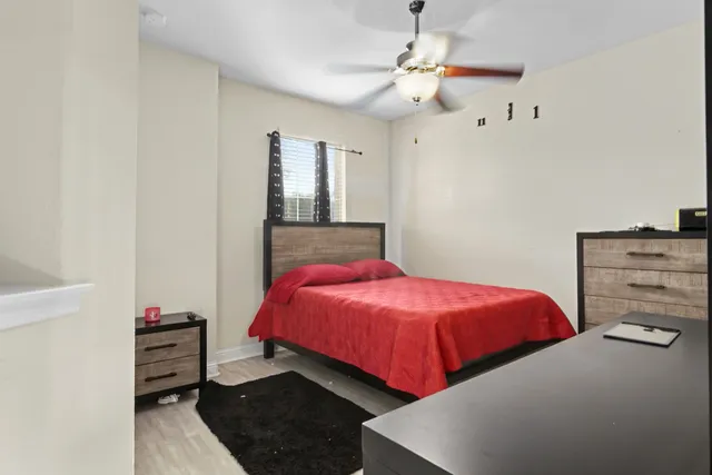 a bedroom with a bed and a chandelier