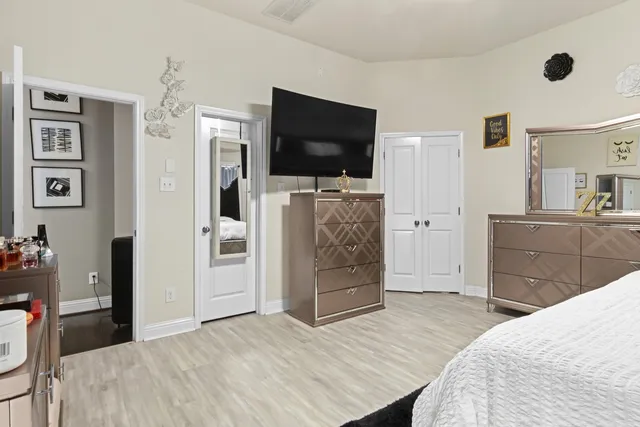 a bedroom with furniture and flat screen tv