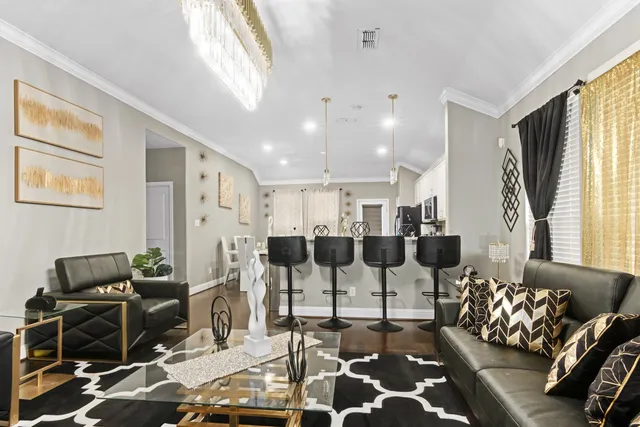 a living room with furniture and wooden floor